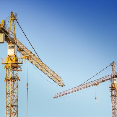 A pair of cranes on a construction site